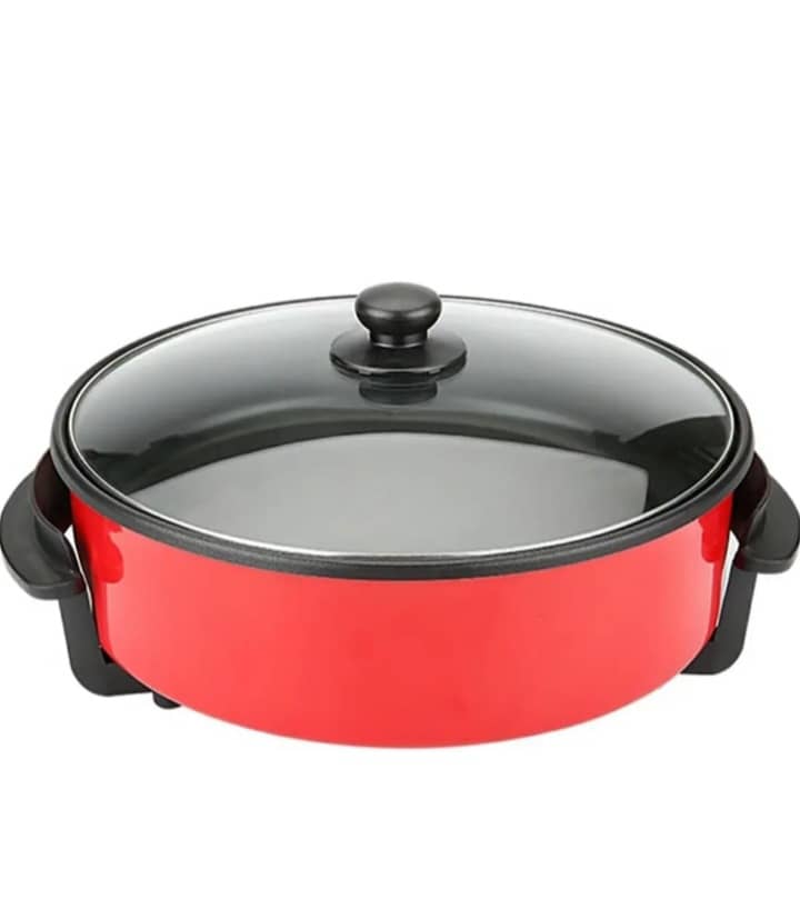 Poêle électrique rouge avec couvercle en verre, contenant une pizza cuite, sur une table en bois. — vue 3